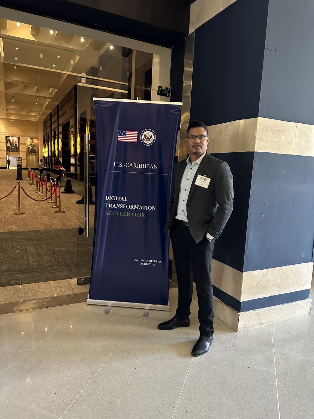 Eldon Marks beside the U.S.-Caribbean Digital Transformation Accelerator banner