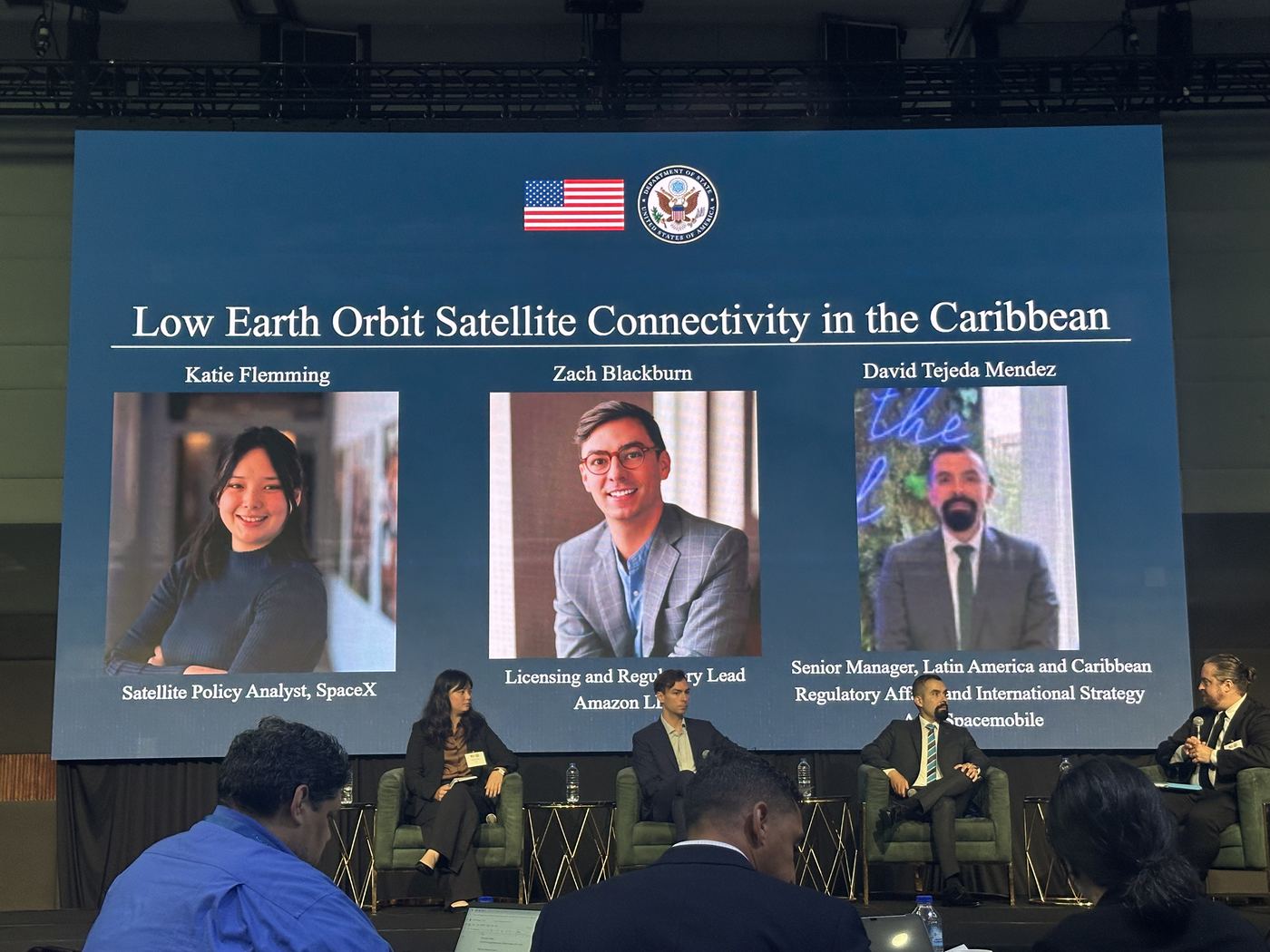 Four panellists on stage below a slide reading Low Earth Orbit Satellite Connectivity